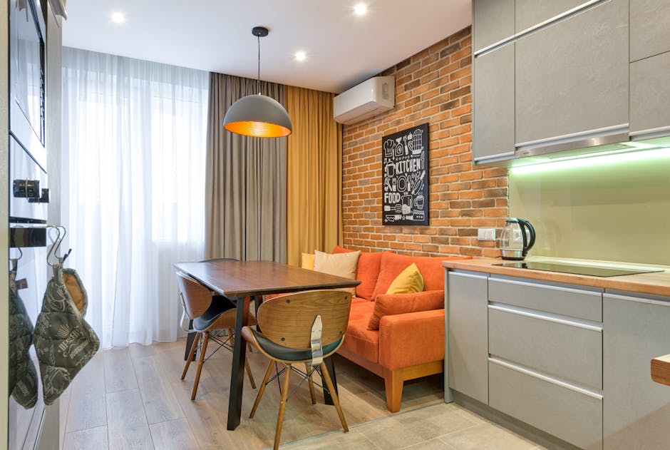 Modern kitchen and dining area with wall-mounted air conditioning unit providing comfortable indoor air quality