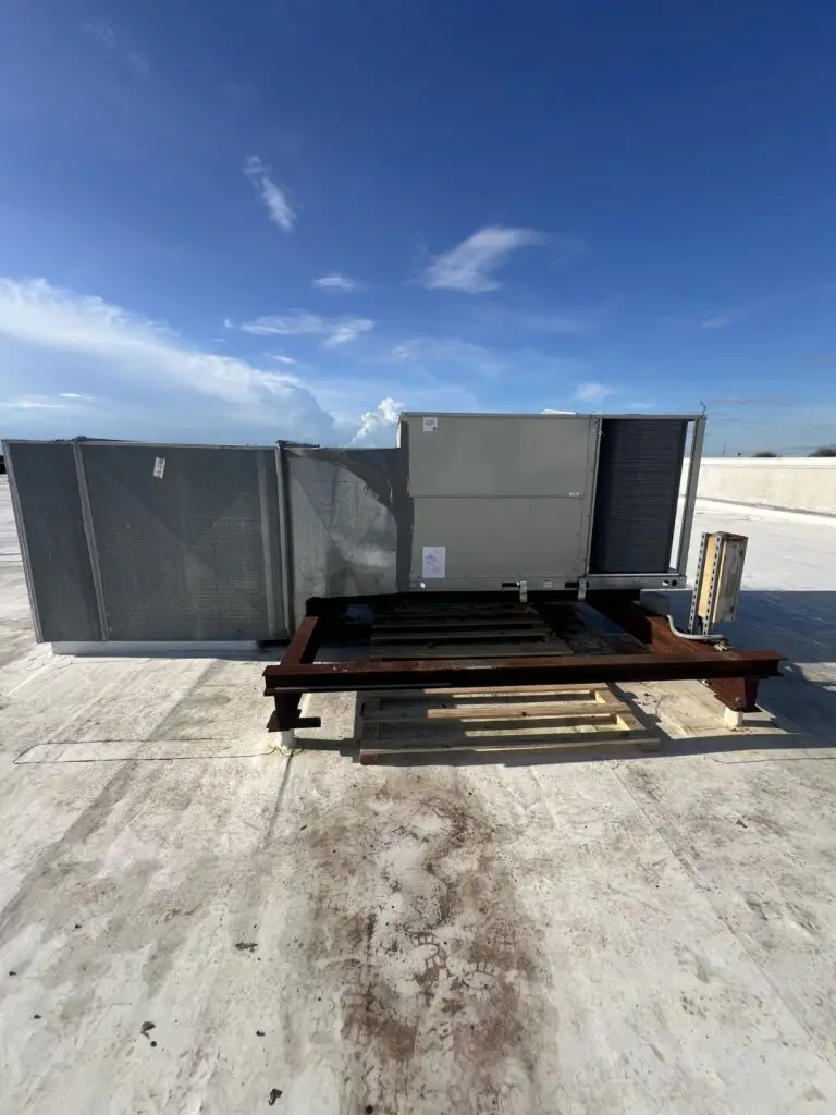 Commercial rooftop HVAC unit (RTU) inspection and maintenance on a flat industrial roof. CleanAirPros provides professional commercial air conditioning repair and maintenance services for businesses in the 813 area.