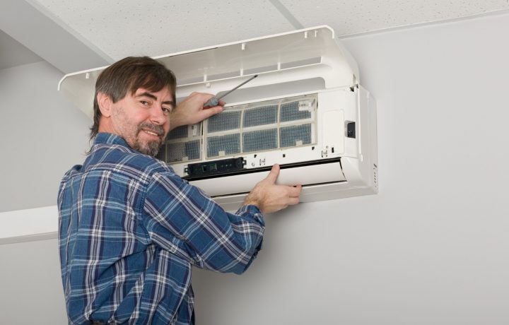 HVAC technician fixing household AC