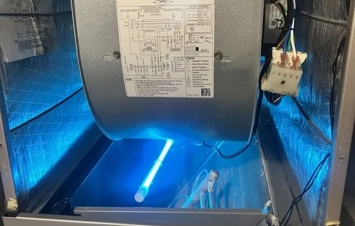 Close-up of an HVAC blower motor housing showing the manufacturer specification label and electrical wiring diagram.