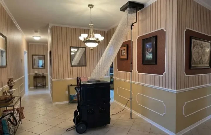 HVAC air duct cleaning service in progress with equipment in a living room, ensuring optimal indoor air quality.