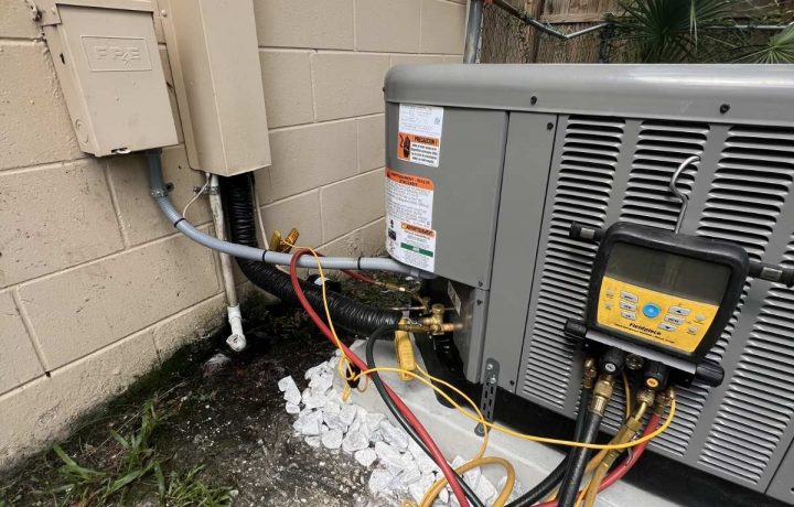 Compressor wiring maintenance showing multiple connections and HVAC components inside the unit.