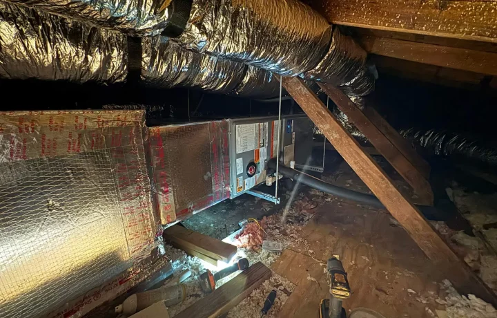 HVAC system installation and ductwork in an attic, showing the layout and components of an HVAC system.