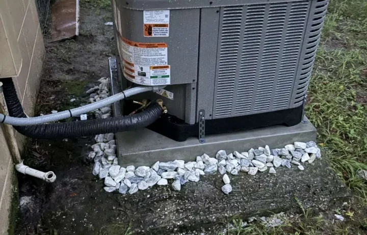 Completed residential HVAC condenser installation with new stone leveling and tidy line set insulation.