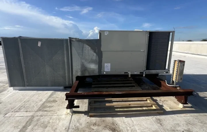 Commercial rooftop HVAC unit (RTU) inspection and maintenance on a flat industrial roof. CleanAirPros provides professional commercial air conditioning repair and maintenance services for businesses in the 813 area.