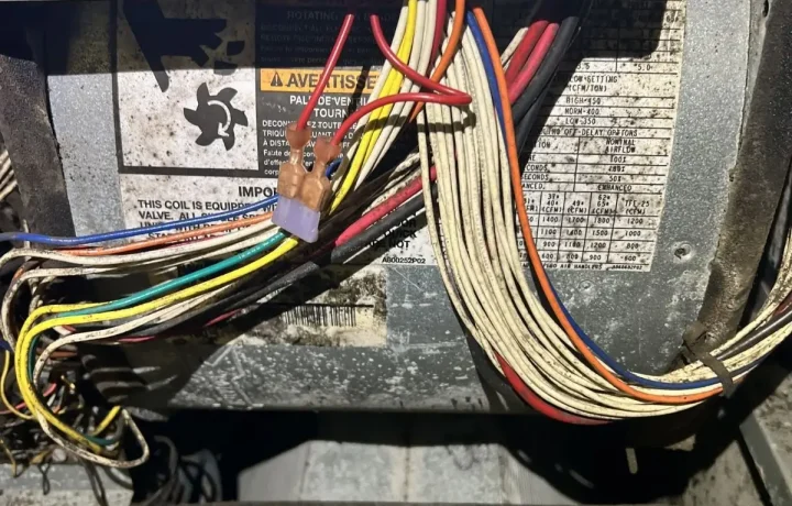 Professional HVAC electrical troubleshooting and wiring repair. CleanAirPros technician cross-referencing system wiring diagrams for accurate furnace and air handler maintenance.