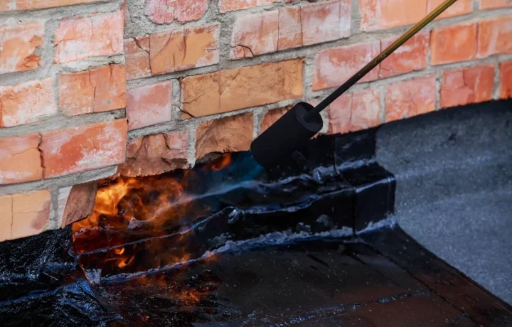 Masonry repairs: Professional technician applying heat to repair brickwork and restore the integrity of the structure